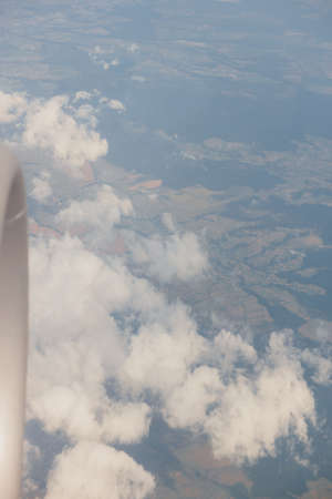 Beautiful sky and jet engine view outside the window of commercial airplane while floating on the atmosphere sky to destination. View of blue sky with cloudy. Aerospace and Transport Industry conceptの写真素材
