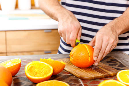 cutting an orangeの写真素材