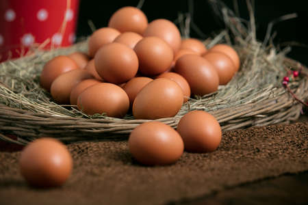 loads of free range eggs on an old rustic retro table in a farmer house kitchenの写真素材