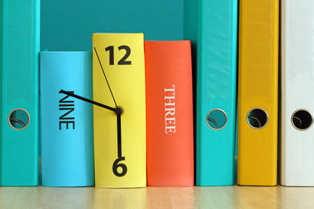 time to work -colored paper binders and clock shaped stackerの写真素材