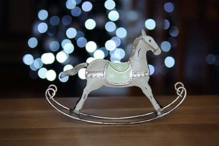 horse - christmas decorations on background of defocused blue lightsの写真素材