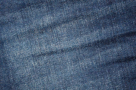 Wrinkled and discolored jeans fabric - backgroundの写真素材
