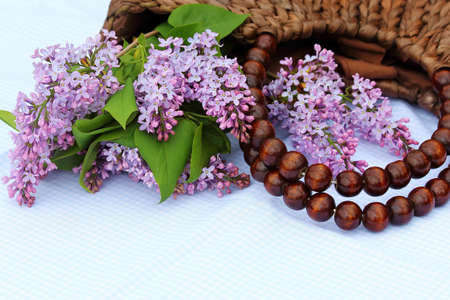 purple lilac in a basket on a table in the gardenの写真素材