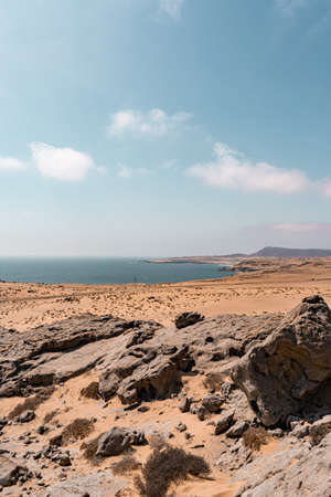 Vertical view of a beach with rocks and blue water in the atacama desert.の写真素材