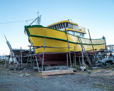 Yellow boat under construction near the beach of Lebu, Chileの写真素材