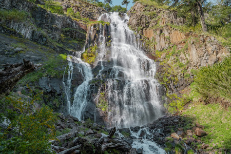 Horizontal shot of waterfall with vegetation on the sides in southern Chile