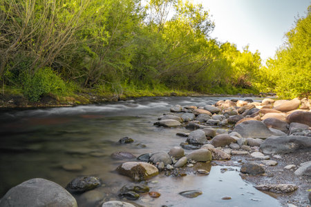 Flowing river with silk effect and rocks on the sides in southern Chileの写真素材