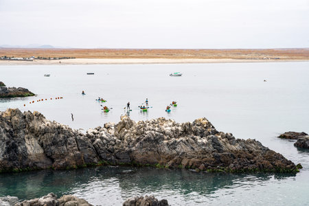 Vertical view of the turquoise waters of BahÃ­a Inglesa with tourists doing water sports and...