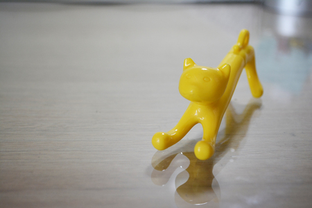 a yellow toy cat with a white backgroundの写真素材