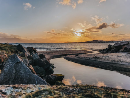 Sunset over the sea with stones in the foreground. long exposureの写真素材