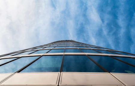 View on glass office building from bottom on a sunny dayの写真素材