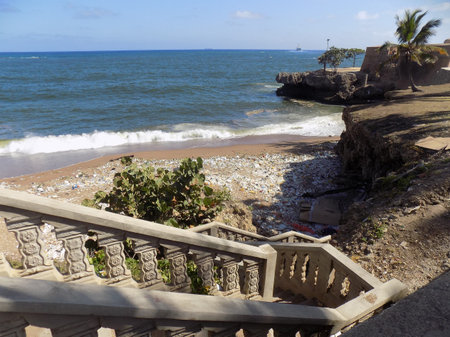 steps leading down to a beach with trashの写真素材