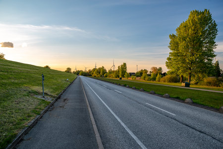 Lonely road on the dike at sunsetの写真素材