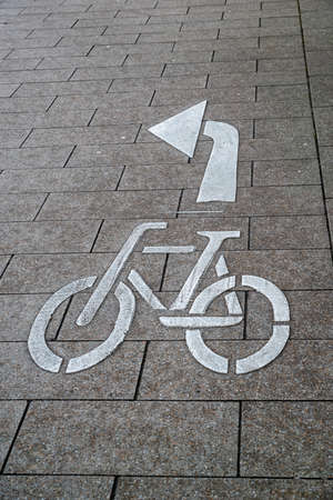 Bicycle marking on the road with an arrow to turn leftの写真素材