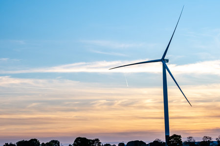 <p>the silhouette of a pinwheel at sunset with a blue and orange sky</p><p><br></p>
