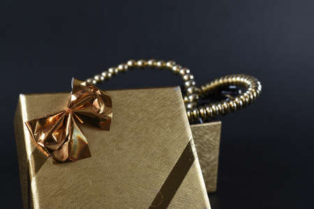 a golden gift on a black backgroundの写真素材