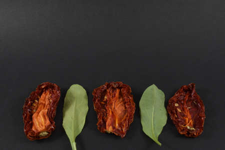 some dried tomatoes on a black backgroundの写真素材