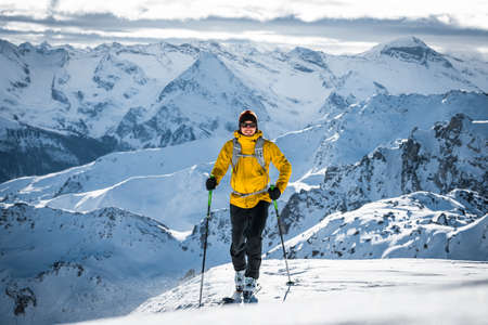 Austria, December 26 2018. Ski touring man in high alpine landscape with snowy trees. Ski touring in spectacular mountains in Tirol, Austriaのeditorial素材
