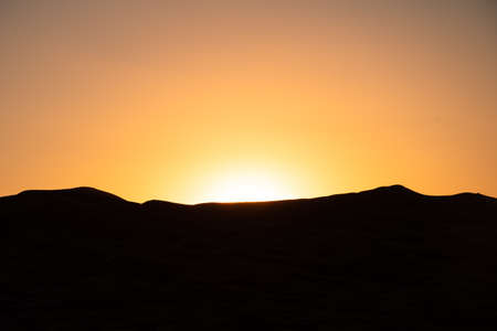 Golden sunrise over the Sahara dunesの写真素材