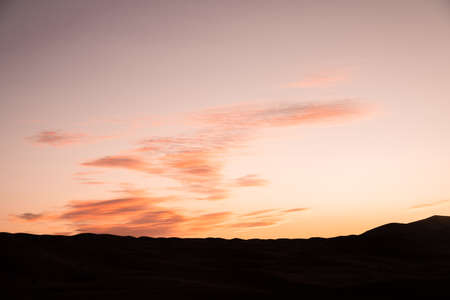 Goldskies before the sunrise in the dunes of Erg Chebbi, Saharaの写真素材