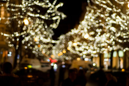 Bokeh yellow Christmas tree lights in the streets of Prague at night