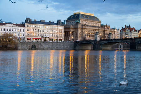 Prague historical center and National Theater seen from an island in the Vltava River at nightfallの写真素材
