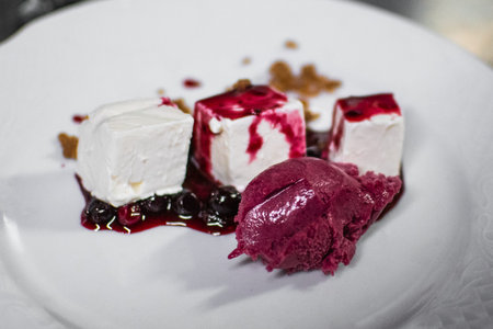 Cheese dessert with red fruits ice cream and marmalade served in a restaurant