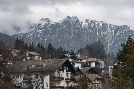 Little town at the feet of the snowy Dolomite in the background