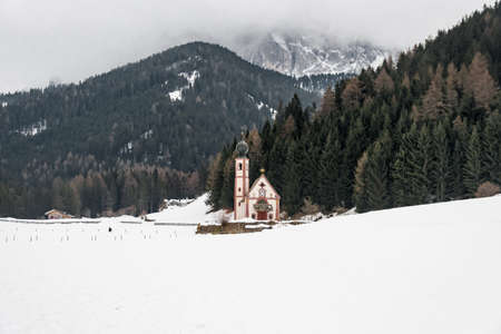 Little Saint John's church in Val di Funes, Dolomite during snowy winterの写真素材
