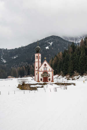 Little Saint John's church in Val di Funes, Dolomite during snowy winterの写真素材