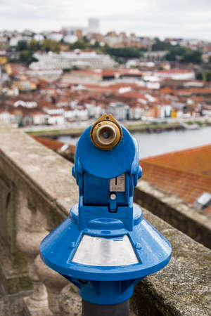 Viewpoint in Porto, Portugal, with a fixed blue binocular. On the background we can see the Douro river and its riverbank.の写真素材