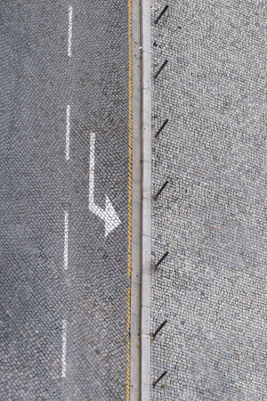 Stoned road in Porto, portugal, seen from Torre dos ClÃ©rigos. There is the road with a painted...