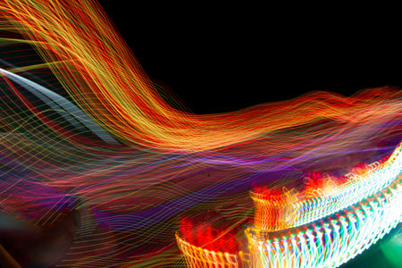Light photography of a fairground attraction in the city.