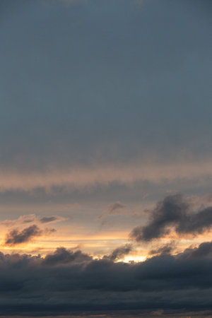 Sunset sky with clouds and orange and blue tones