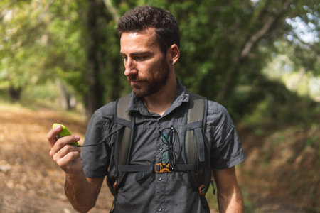 Boy in the mountain, hiking route and watching the GPS. Concept sport. nature. Outdoors.