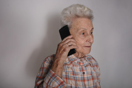 Older person with the smartphone making a call, having pleasant conversation, chatting, hearing good...