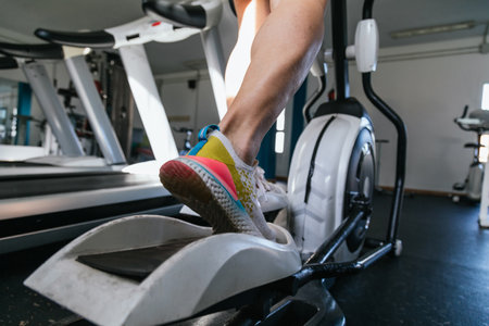 Young male using elliptical.Concept of health and well-being.の写真素材