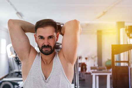 Man training dumbbell triceps. Sport.
