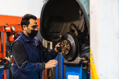Mechanic repairing car brake pads. Vehicle repair conceptの写真素材