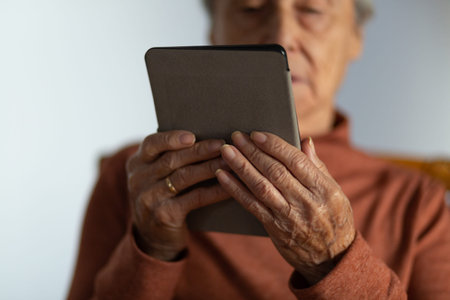 Senior woman using an e book. Selective focus.の写真素材