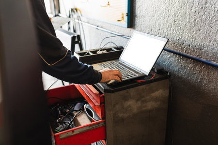 Mechanic diagnosing the car with the computer. Concept of car repair.