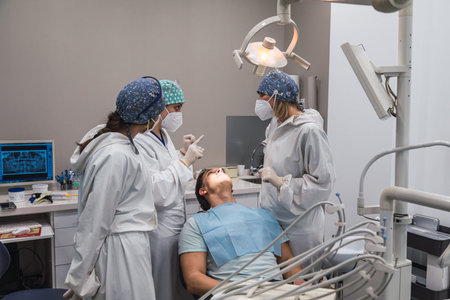 Three dental doctors talking to the patient about the procedure. Dentists.の写真素材