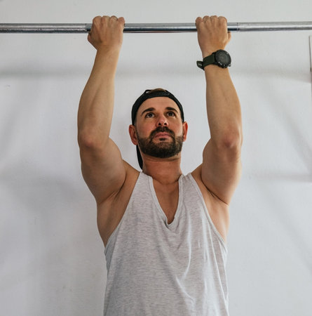 Man doing barbell exercises for the back at the gym.