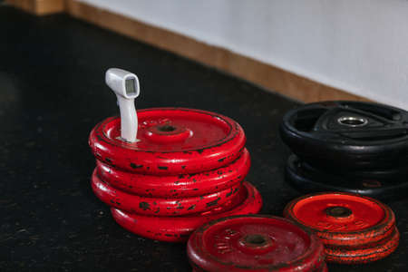 Weight set in the gym, infrared thermometer.の写真素材