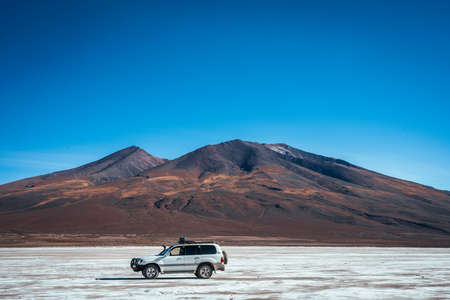 A car in the salt flats of Bolivia, Salar de Uyuniの写真素材