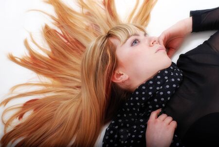 woman with red hair is lying on floorの写真素材