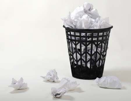 full wastepaper with crumpled papers on white backgroundの写真素材