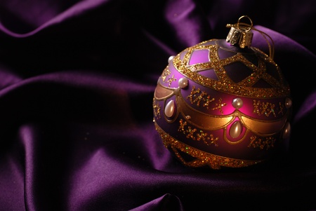 Violet Christmas ball on a shine background. Selective focus.の写真素材
