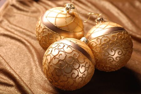Golden christmas balls on a shine background. Selective focus.の写真素材
