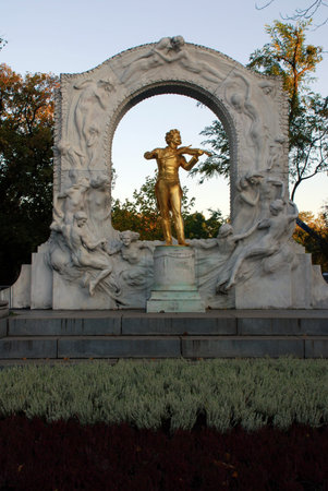 The golden statue of music composer Johann Strauss in StadtPark in Vienna, Austria. Fall afternoon lightの写真素材